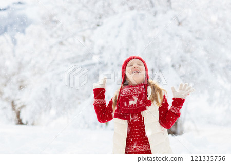 Child playing in snow on Christmas. Kids in winter 121335756