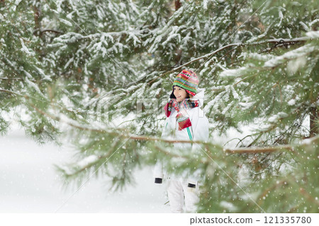 Kids play in snow in winter park Kids play in snow in winter park 121335780