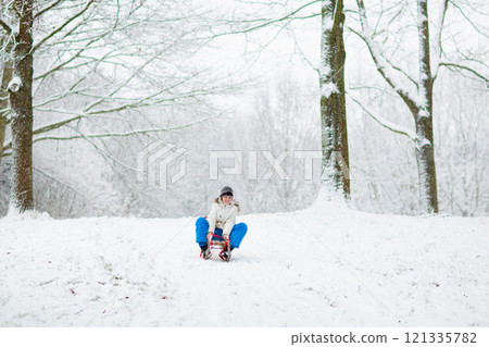 Kids play in snow in winter park Kids play in snow in winter park 121335782