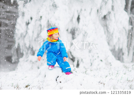 Kids play in snow in winter park Kids play in snow in winter park 121335819