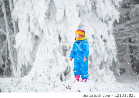 Kids play in snow in winter park Kids play in snow in winter park 121335825