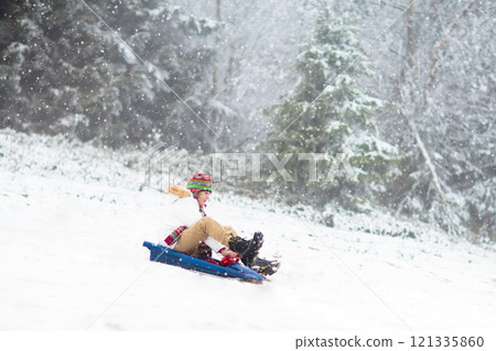 Kids play in snow in winter park Kids play in snow in winter park 121335860