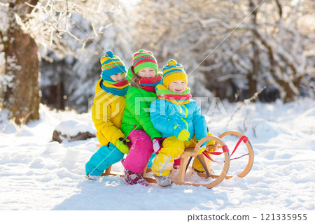 Kids play in snow. Winter sled ride for children Kids play in snow. Winter sled ride for children 121335955
