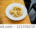 "Juicy dumplings served on a plate" 121336210