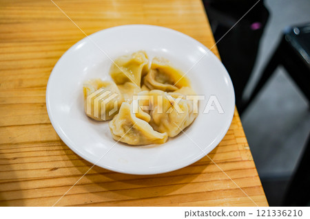 "Juicy dumplings served on a plate" "Juicy dumplings served on a plate" 121336210