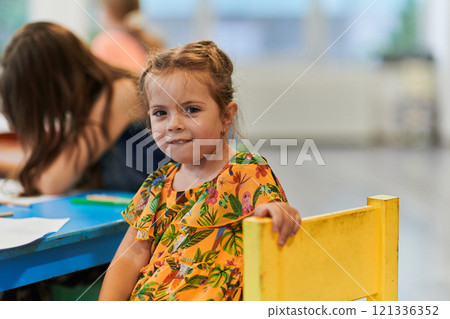 Creative kids sitting in a preschool institution, draw and have fun while they get an education 121336352