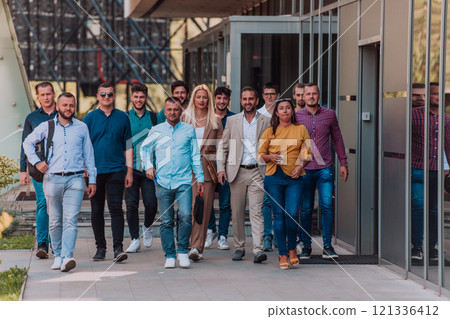 A diverse group of businessmen and colleagues walking together by their workplace, showcasing collaboration and teamwork in the company. A diverse group of businessmen and colleagues walking together by their workplace, showcasing collaboration and teamwork in the company. 121336412