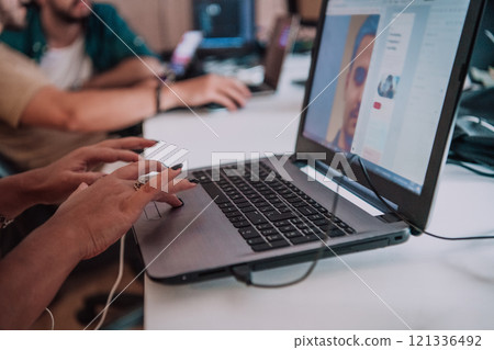 Close up image of woman hands typing on laptop computer keyboard and surfing the internet on office table, online, working, business and technology, internet network communication concept 121336492