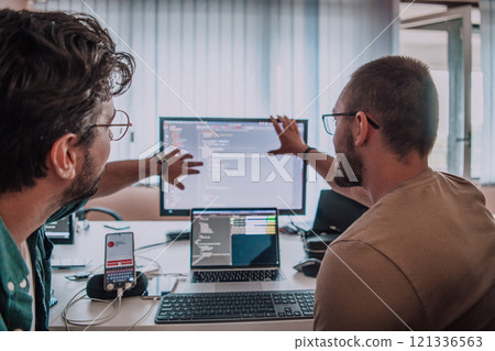 Programmers engrossed in deep collaboration, diligently working together to solve complex problems and develop innovative mobile applications with seamless functionality. Programmers engrossed in deep collaboration, diligently working together to solve complex problems and develop innovative mobile applications with seamless functionality. 121336563
