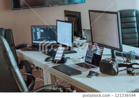 Computer screens running programming code in empty software developing agency office and computers parsing data algorithms in background. Neural network servers cloud computing in data room. Computer screens running programming code in empty software developing agency office and computers parsing data algorithms in background. Neural network servers cloud computing in data room. 121336594