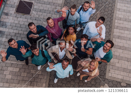 A top view photo of group of businessmen and colleagues standing together, looking towards the camera, symbolizing unity and teamwork. 121336611