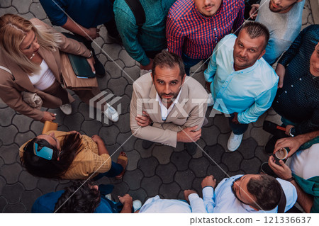 A top view photo of group of businessmen and colleagues standing together, looking towards the camera, symbolizing unity and teamwork. 121336637
