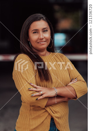 A powerful portrait of a businesswoman, standing confidently with her arms crossed, representing the determination of the female gender and embodying strength and success A powerful portrait of a businesswoman, standing confidently with her arms crossed, representing the determination of the female gender and embodying strength and success 121336720