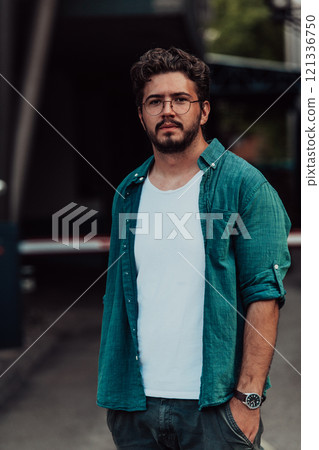 A portrait of a modern man, exuding confidence and style, against an outdoor backdrop, showcasing his charisma and fashionable demeanor. 121336750