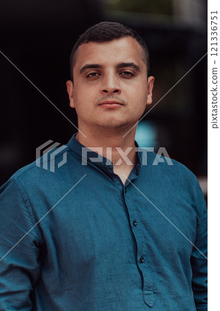 A portrait of a modern man, exuding confidence and style, against an outdoor backdrop, showcasing his charisma and fashionable demeanor. 121336751