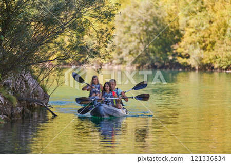 A group of friends enjoying having fun and kayaking while exploring the calm river, surrounding forest and large natural river canyons 121336834