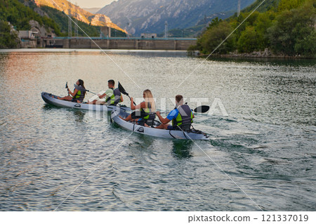 A group of friends enjoying having fun and kayaking while exploring the calm river, surrounding forest and large natural river canyons 121337019