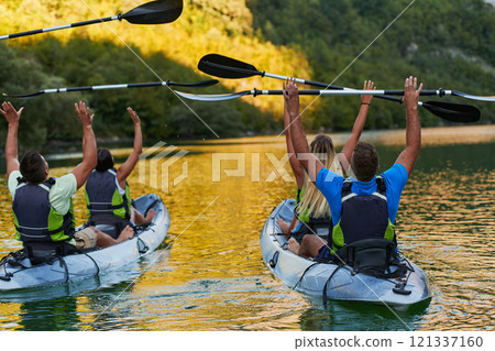 A group of friends enjoying having fun and kayaking while exploring the calm river, surrounding forest and large natural river canyons 121337160