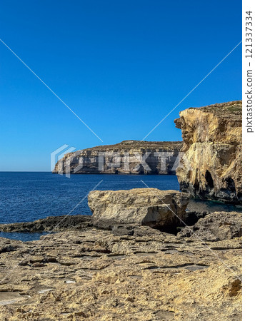 Fantastic views of rocky coast on a sunny day with blue sky at Gozo 121337334