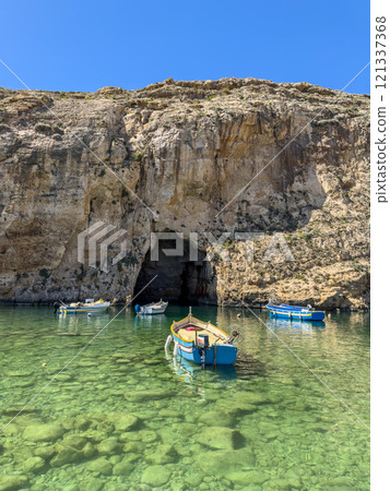 The Inland Sea and tourist boat. Dwejra is a lagoon of seawater on the island of Gozo. 121337368