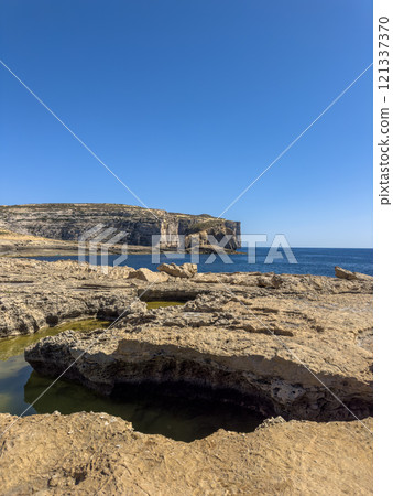 Fantastic views of rocky coast on a sunny day with blue sky at Gozo Fantastic views of rocky coast on a sunny day with blue sky at Gozo 121337370