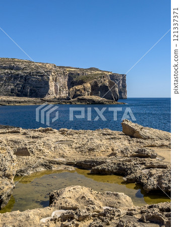 Fantastic views of rocky coast on a sunny day with blue sky at Gozo Fantastic views of rocky coast on a sunny day with blue sky at Gozo 121337371