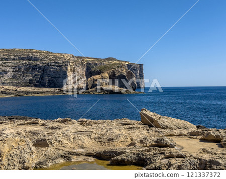 Fantastic views of rocky coast on a sunny day with blue sky at Gozo 121337372