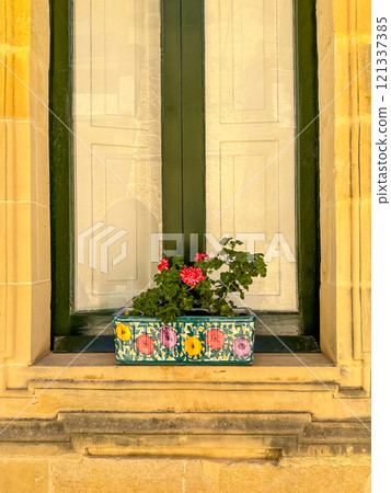 Flowerpot on a windowsill on a sunny summer day Flowerpot on a windowsill on a sunny summer day 121337385