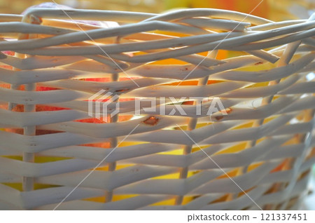 Wicker basket texture. Fruits can be seen behind the wall of the basket. High quality photo 121337451