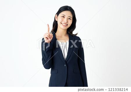 A career woman in a suit pointing and showing something 121338214