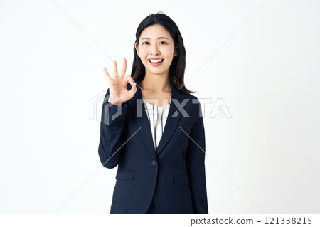 A career woman in a suit making an OK sign with her fingers A career woman in a suit making an OK sign with her fingers 121338215