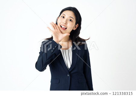 A woman in a suit cheering and shouting loudly 121338315