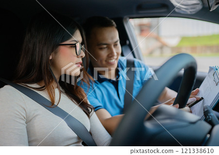 A Couple Engaged in an Exciting and Informative Driving Lesson Inside Their Car A Couple Engaged in an Exciting and Informative Driving Lesson Inside Their Car 121338610