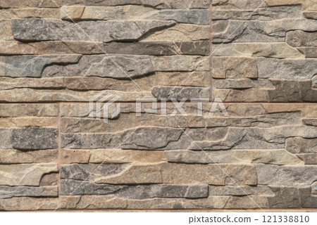 A wall made of stone with a brown and gray color A wall made of stone with a brown and gray color 121338810