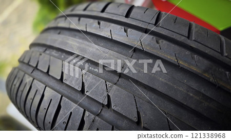 detailed image of a brand new car tire showcasing its intricate tread pattern for enhanced grip and performance detailed image of a brand new car tire showcasing its intricate tread pattern for enhanced grip and performance 121338968