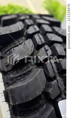 detailed image of a brand new car tire showcasing its intricate tread pattern for enhanced grip and performance 121338970