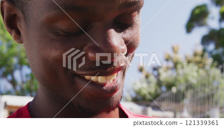 At dog shelter, man smiling and spending sunny day with dogs outdoors 121339361