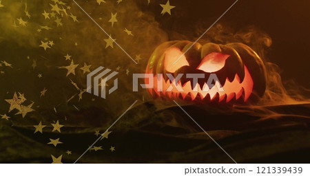 Glowing jack lantern with stars image over smoky background 121339439