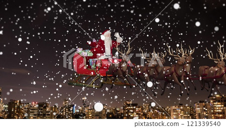 Image of snow falling over christmas santa claus in sleigh with reindeer 121339540