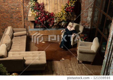 young girl christmas holiday celebration woman fireplace tree home alone cozy new year 121339593