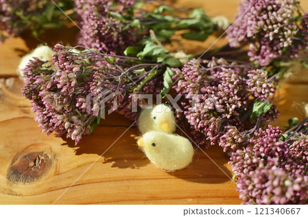 A small bouquet of dried Japanese eupatorium flowers and a felt chick A small bouquet of dried Japanese eupatorium flowers and a felt chick 121340667