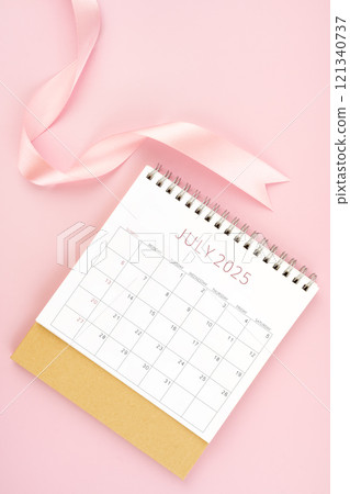 July 2025 desk calendar with pink ribbon. July 2025 desk calendar with pink ribbon. 121340737
