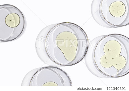 A skin serum or body gel or a drop of oil in a petri dish. A skin serum or body gel or a drop of oil in a petri dish. 121340891