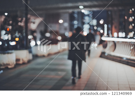 Blurred cityscape at night and back view of businessman Blurred cityscape at night and back view of businessman 121340969