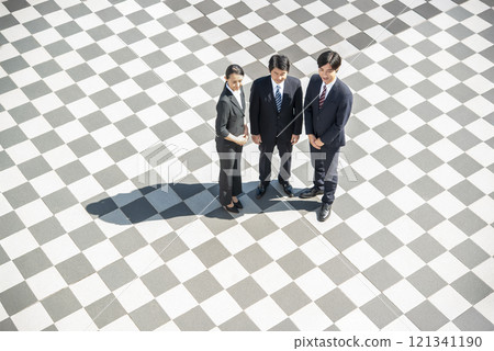 Businessmen and businesswomen standing side by side in a square Businessmen and businesswomen standing side by side in a square 121341190
