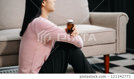 woman sit Depression Standing by window and anxiety Copy space. 121342771