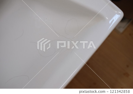 Woman's hair loss accumulated in the washbasin Woman's hair loss accumulated in the washbasin 121342858