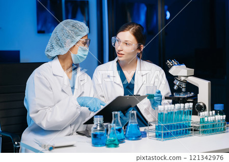 Scientist two woman with tablet and laptop, laboratory and ecofriendly science. Agriculture, research and scientists with online reading, test samples 121342976