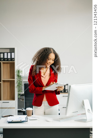 Confident business expert attractive smiling young woman holding digital tablet on desk in creative office. Confident business expert attractive smiling young woman holding digital tablet on desk in creative office. 121343456