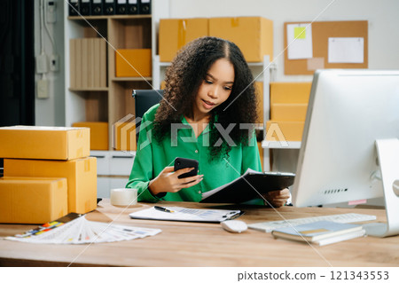 Startup small business SME, Entrepreneur owner woman using smartphone or tablet taking receive 121343553